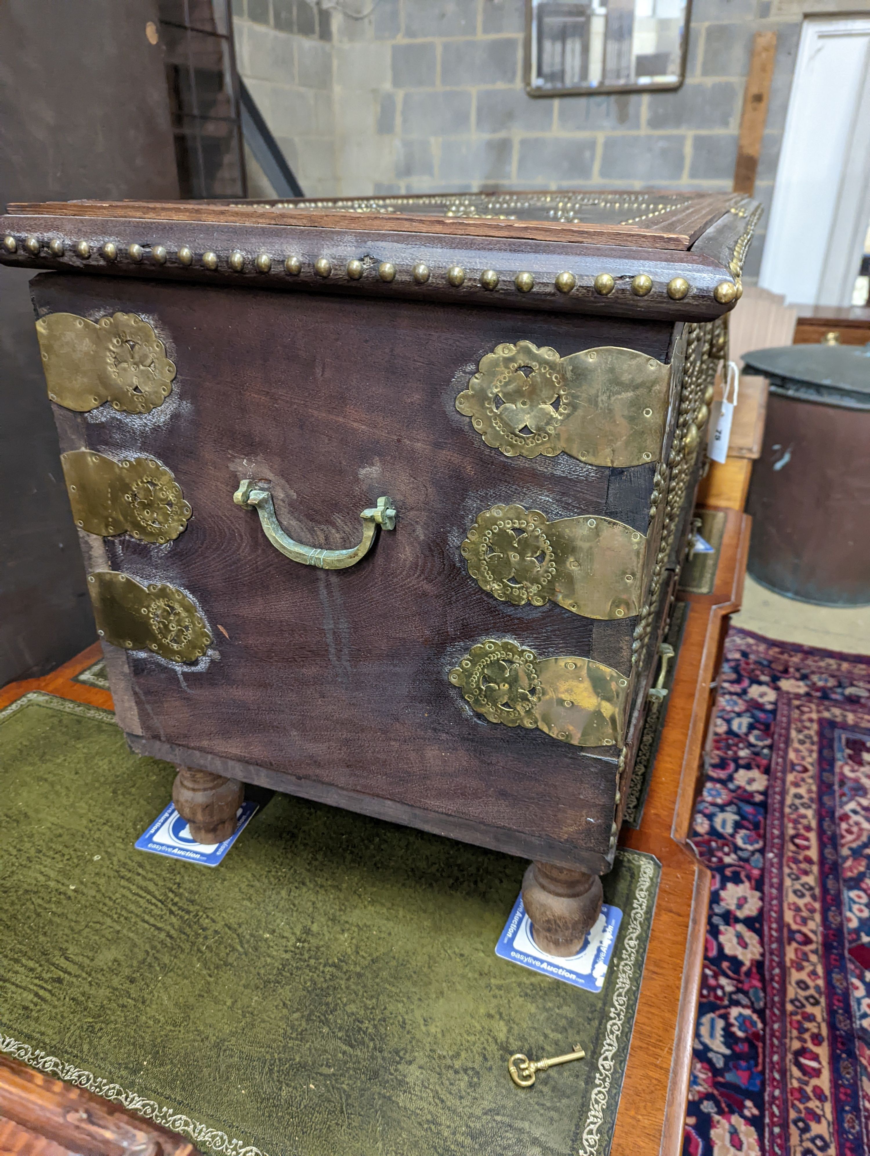 An Eastern brass mounted and studded hardwood trunk, length 113cm, depth 48cm, height 60cm